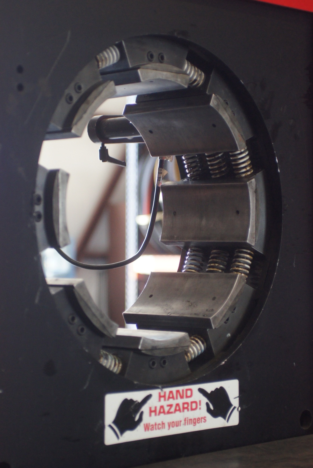 Technician crimping hydraulic hose assembly in Oklahoma City shop